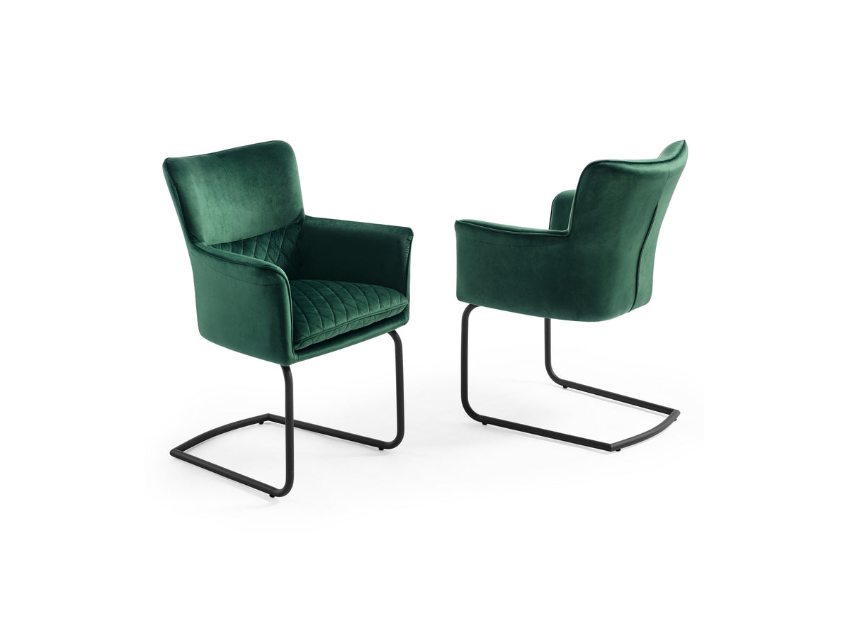 Two Loran green velvet chairs with black metal frames on a white background