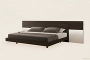 Maia bed with dark wooden frame and gray bedding on a white background