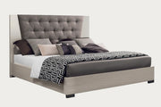 Mont Blanc upholstered bed with pillows and a blanket on a white background.