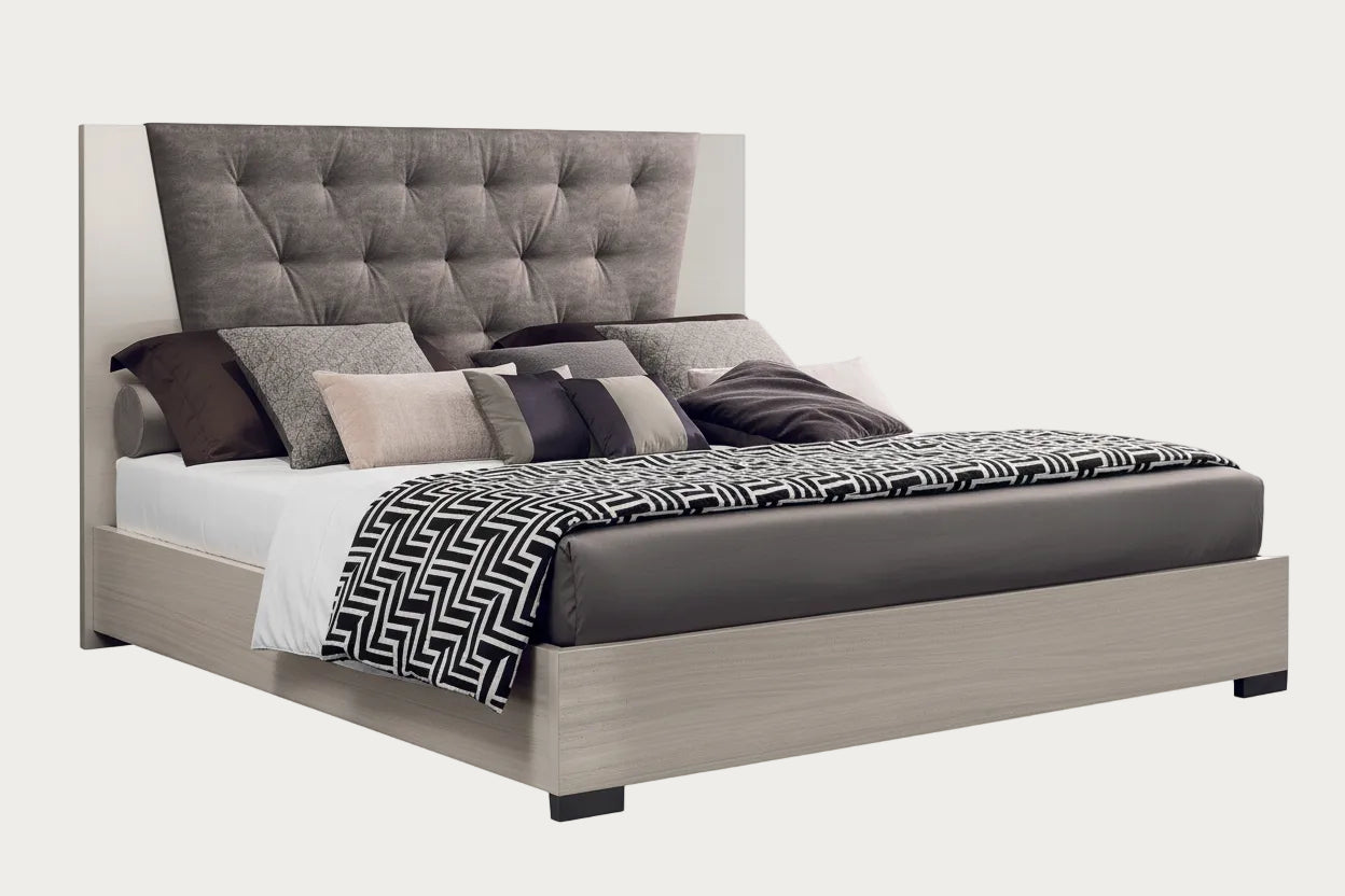 Mont Blanc upholstered bed with pillows and a blanket on a white background.