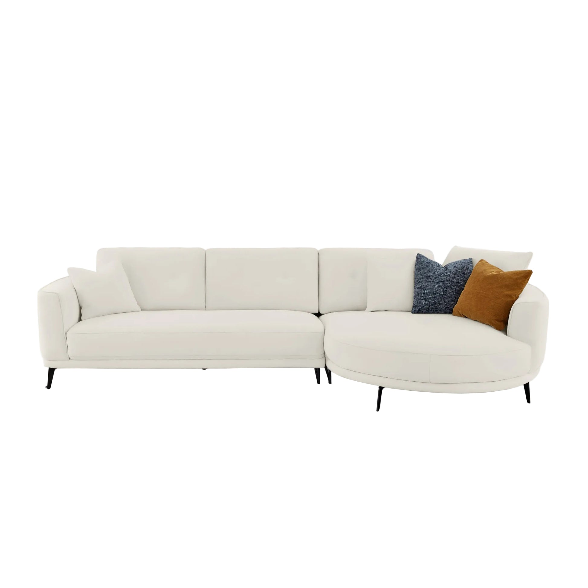 A modern curved white leather sectional sofa with two accent pillows, one dark blue textured throw and one brown velvet throw, set against a plain light gray background.