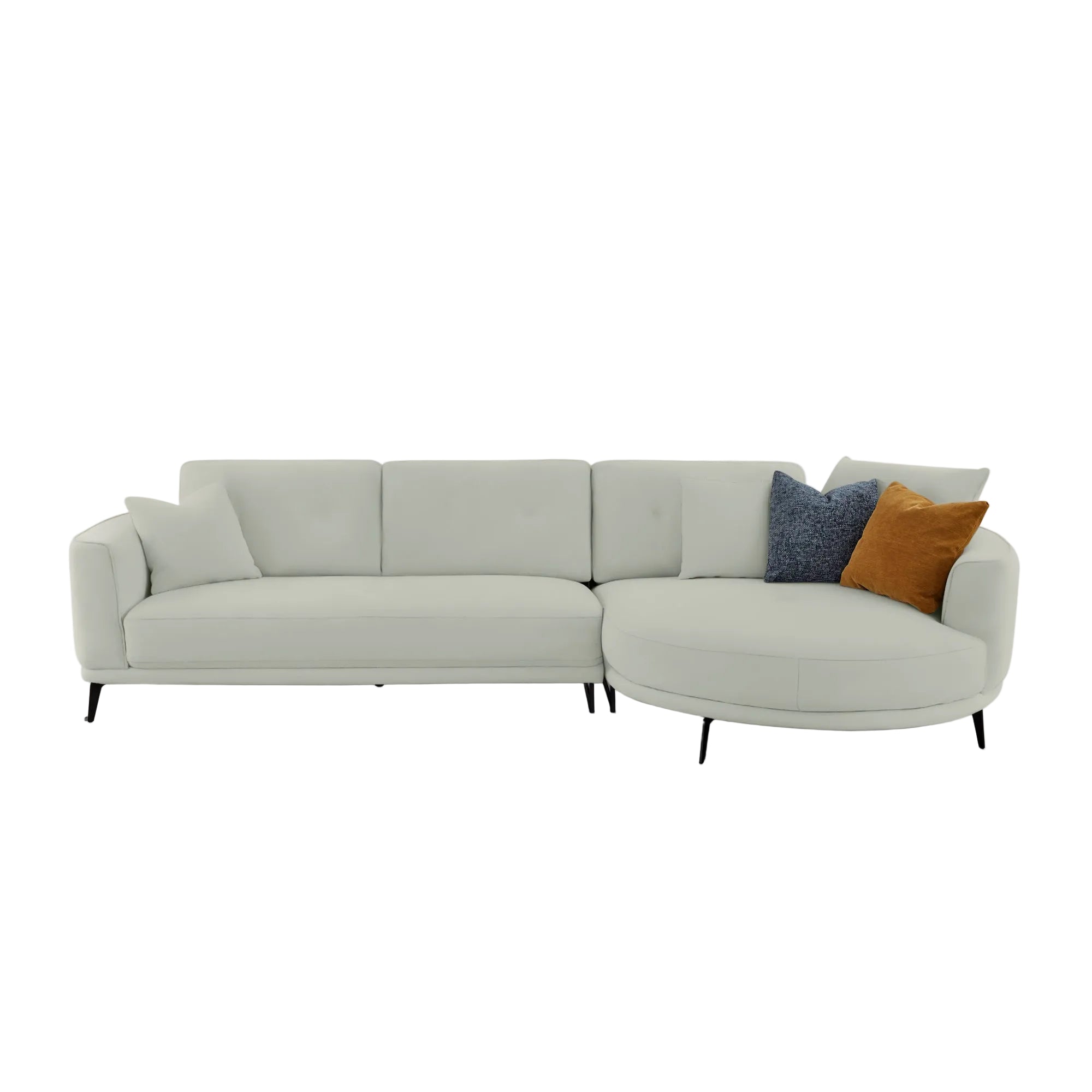 A modern curved light gray fabric sectional sofa with two black metal legs, styled with three throw pillows (one blue textured, one mustard brown, and one solid light gray) against a plain light gray background.