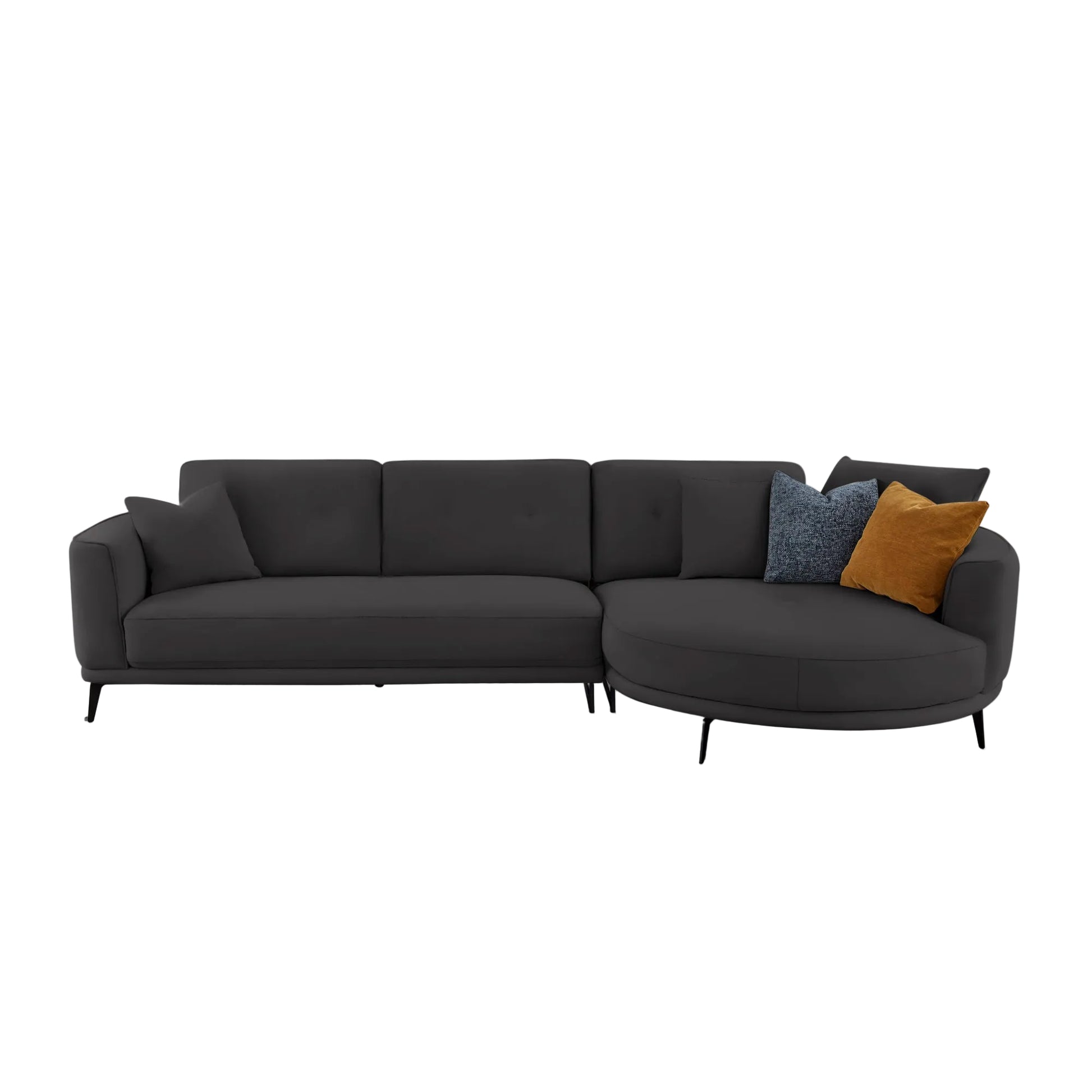 A modern dark gray sectional sofa with a left-facing armrest and a right-facing curved chaise, styled with three accent pillows in blue and mustard yellow, set against a plain light gray background.