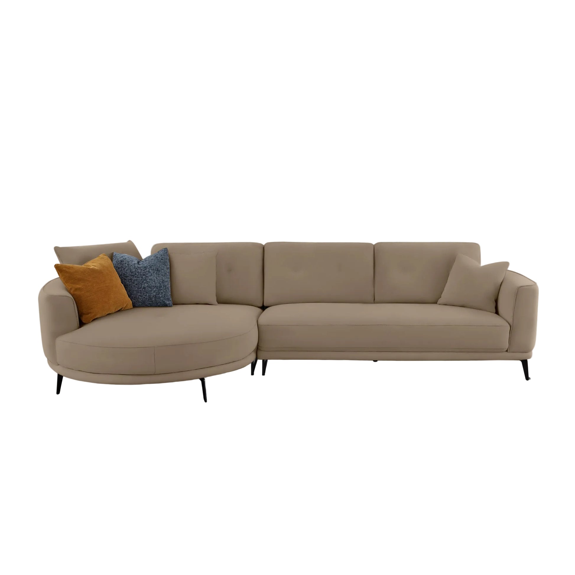 A modern sectional sofa in a warm taupe-beige fabric, featuring a rounded left armrest, two accent pillows (one mustard yellow, one textured blue), and slim black legs, shown against a solid off-white background.