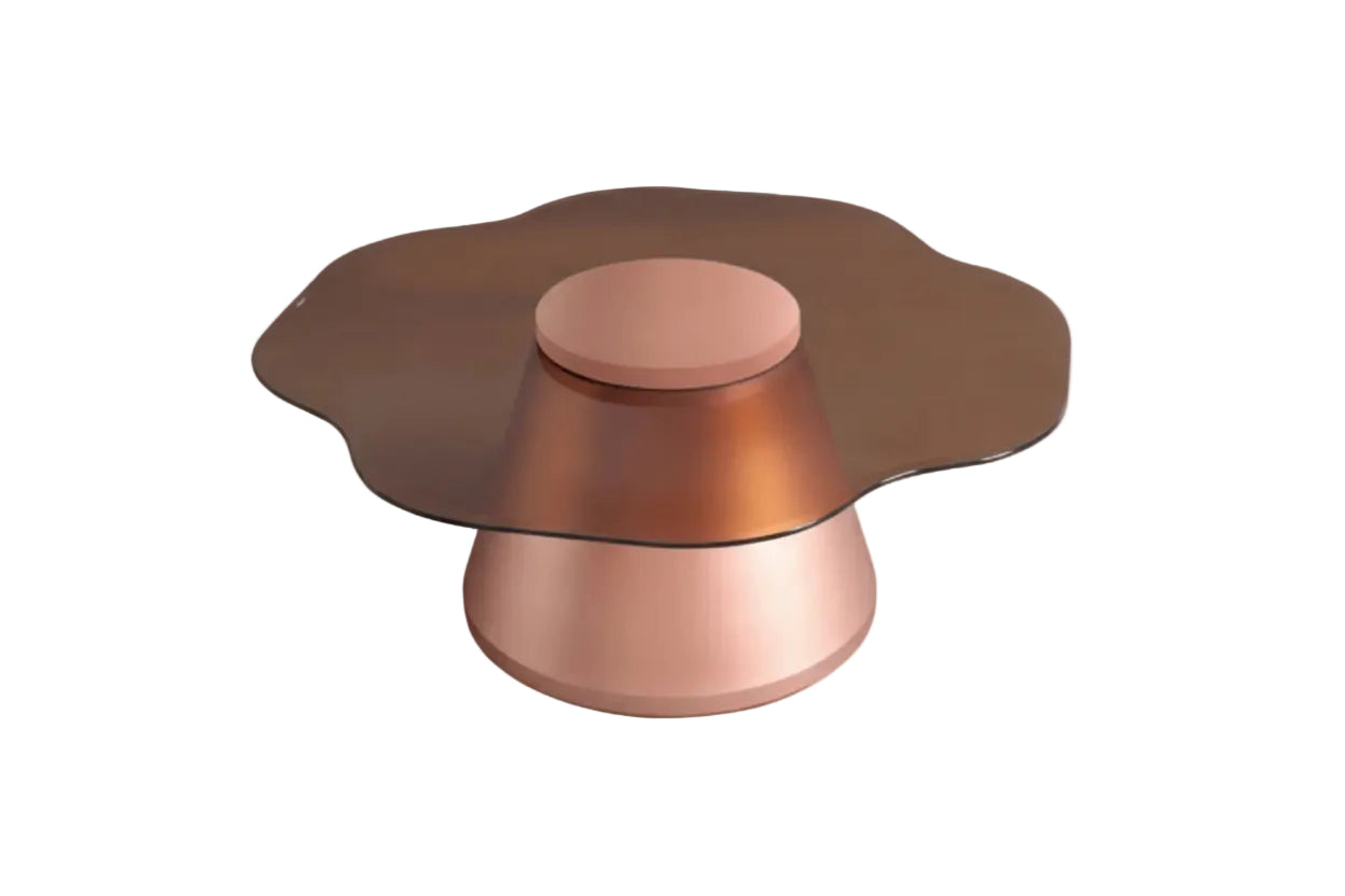 A modern coffee table features a scalloped amber glass top resting on a sleek rose gold metallic pedestal base.