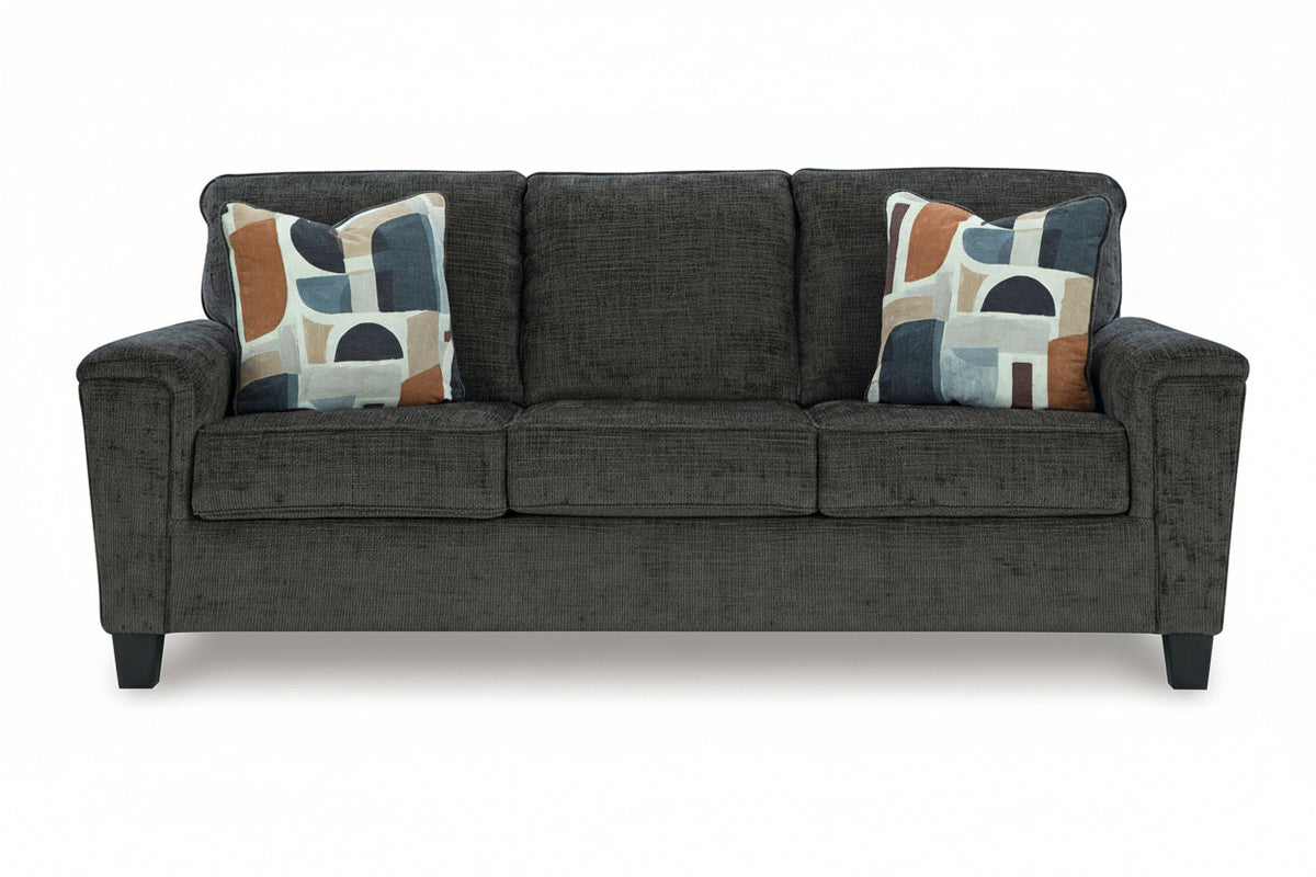 Gray sofa with patterned cushions on a white background