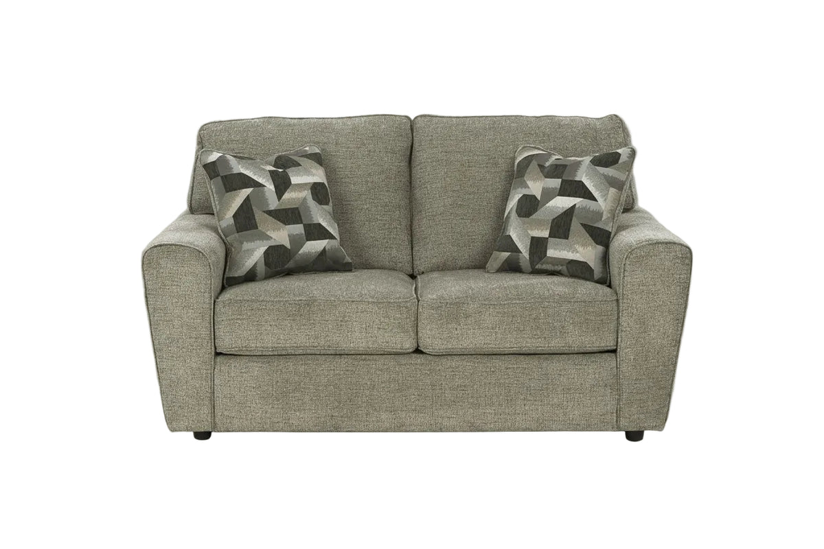Gray sofa with two patterned cushions on a white background