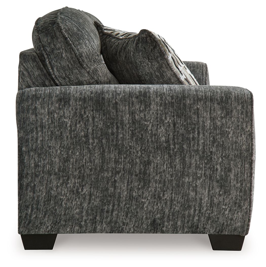 Gray textured sofa with decorative pillows on a white background
