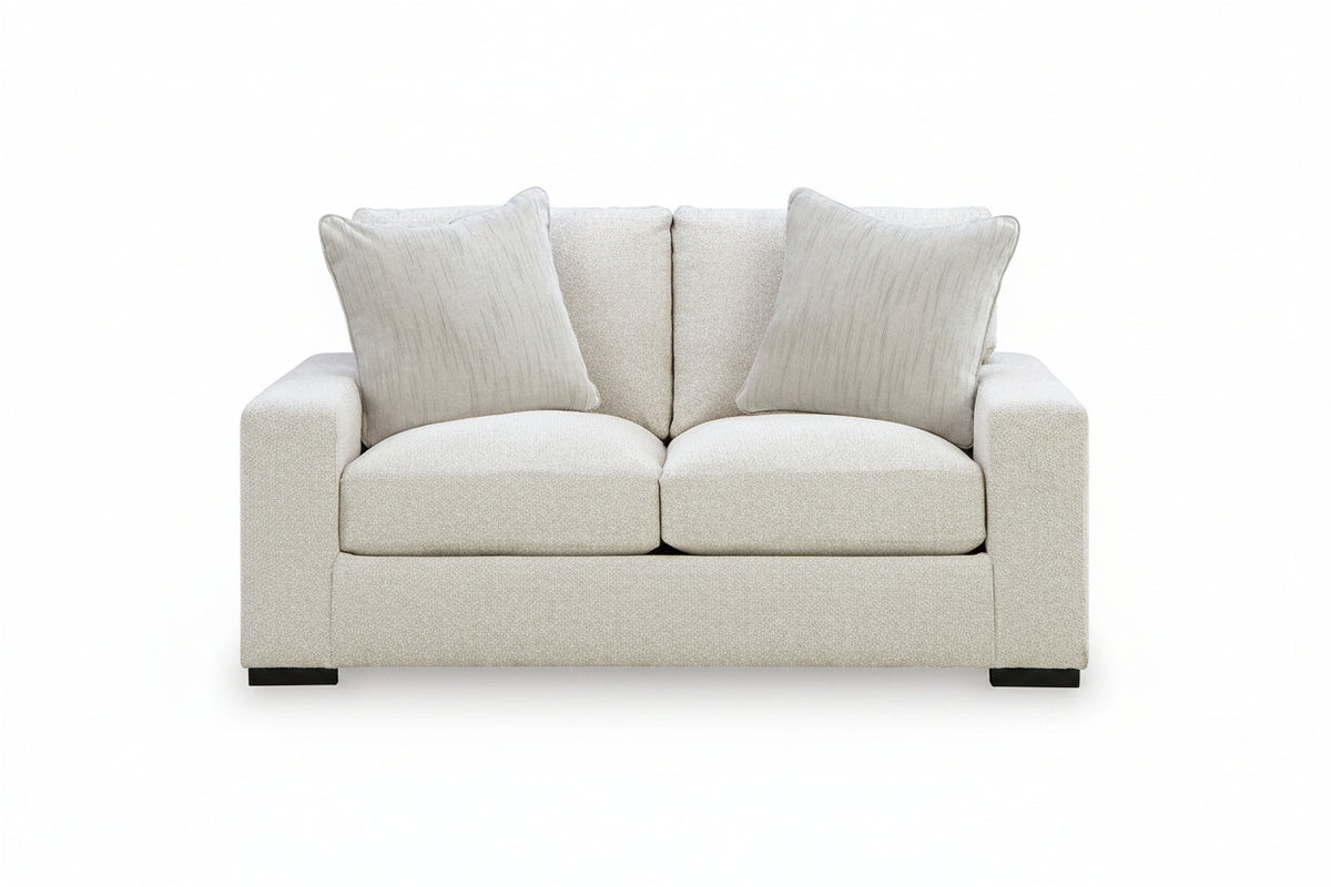 Beige sofa with two cushions on a white background