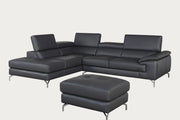 Gray leather sectional sofa with ottoman in a room with a gray wall and pendant light.