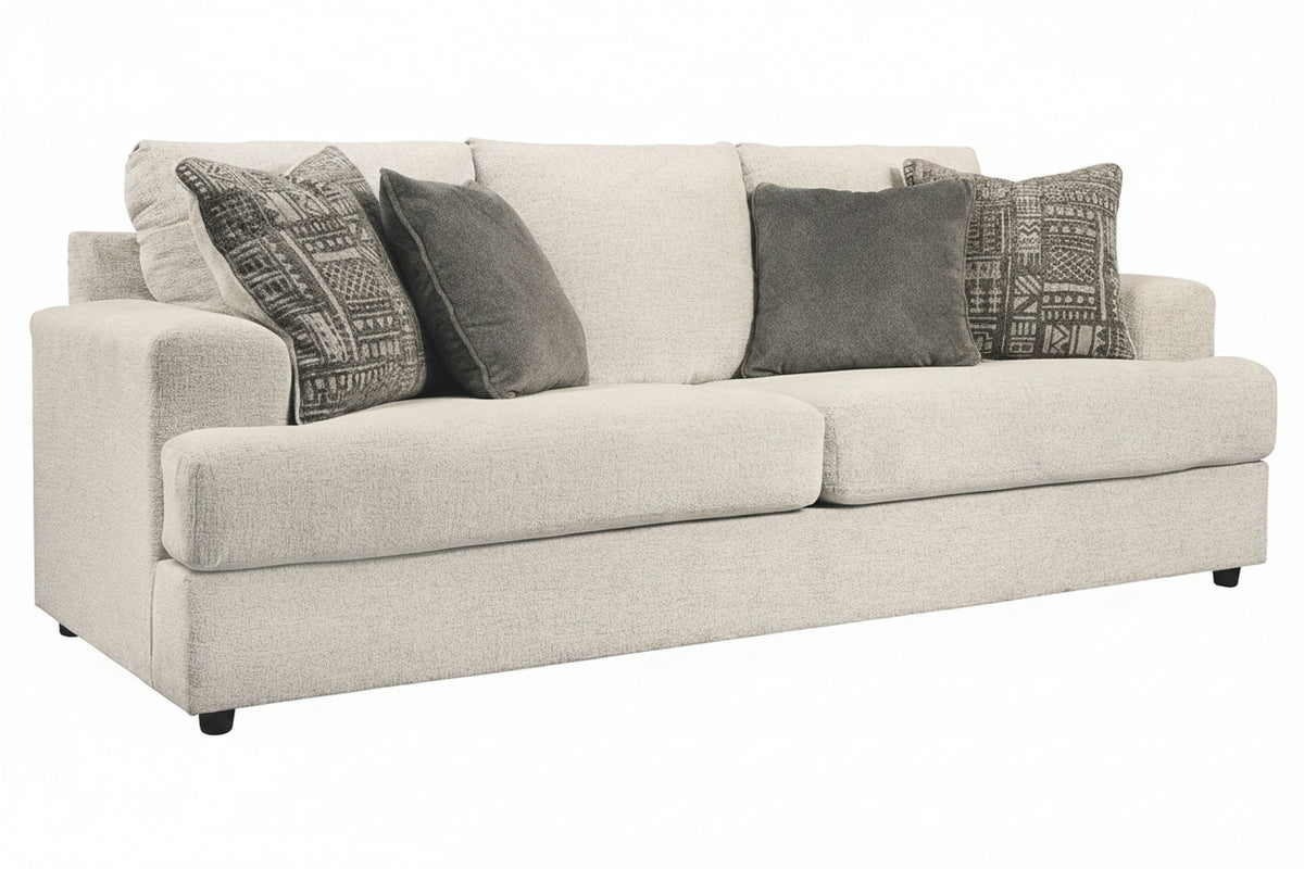 Beige sofa with patterned gray cushions on a white background