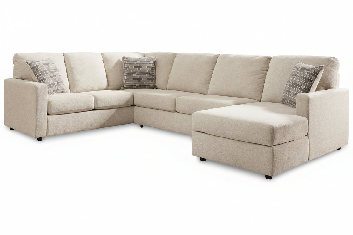 Beige sectional sofa with patterned cushions on a white background