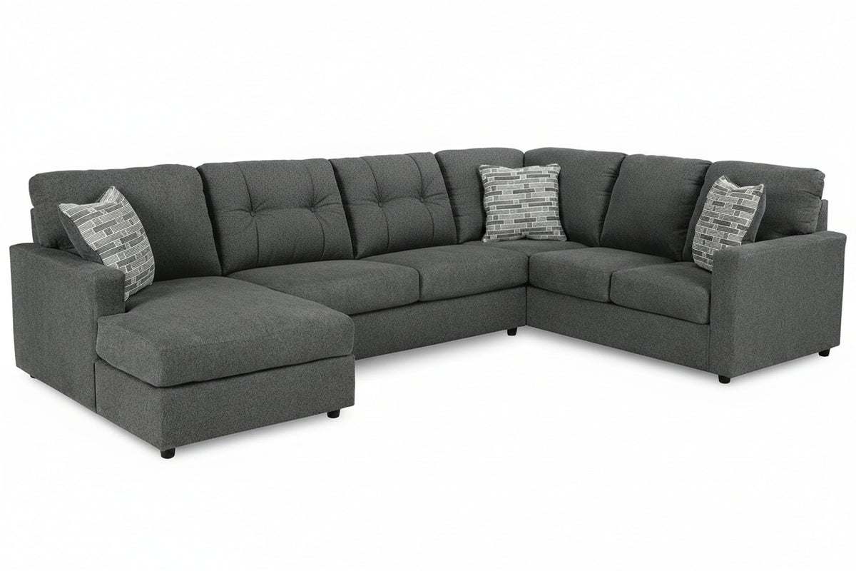 Gray sectional sofa with patterned cushions on a white background