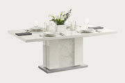 Canova white dining table with marble-like base on a white background
