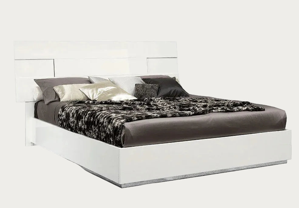 Canova white bed with black and gray bedding on a white background