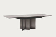 Graphite modern dining table with a gray surface and dark base on a white background