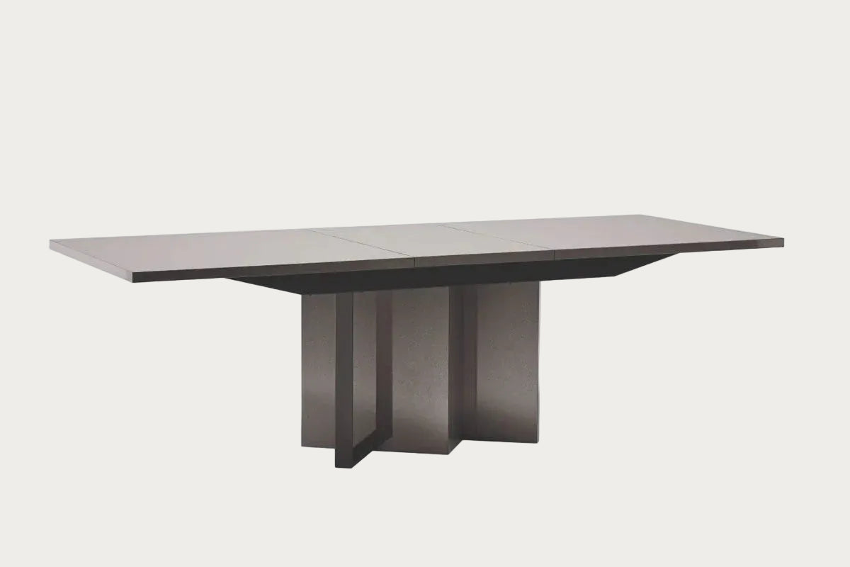 Graphite modern dining table with a gray surface and dark base on a white background