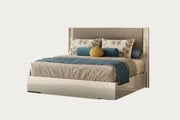 Tullia bed with brown bedding and decorative pillows on a white background.