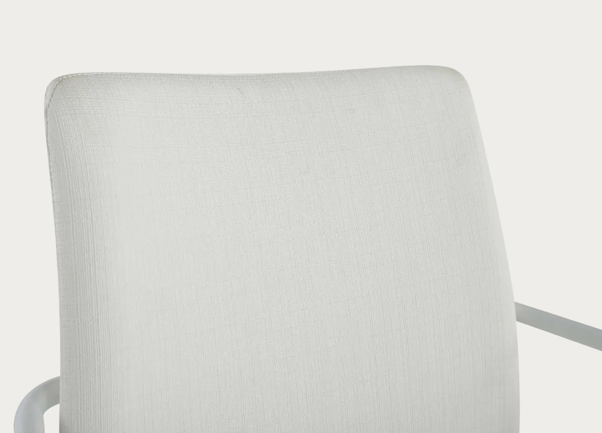 Close-up of a white chair with a textured backrest on a white background