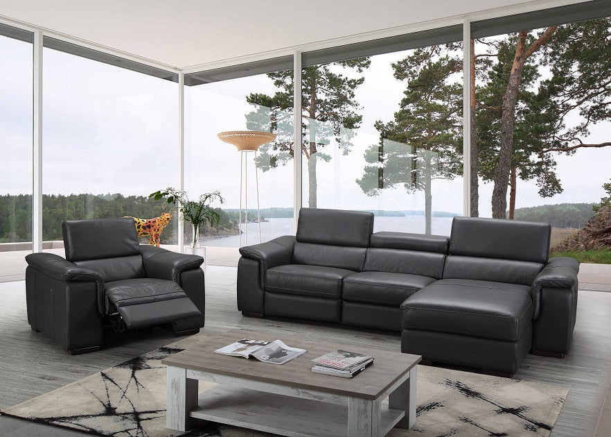 Modern black leather sofa set in a stylish living room with large windows.