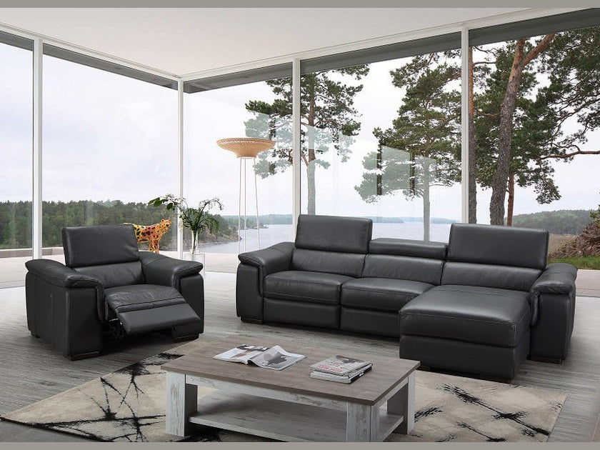 Modern black leather sofa set in a stylish living room with large windows.