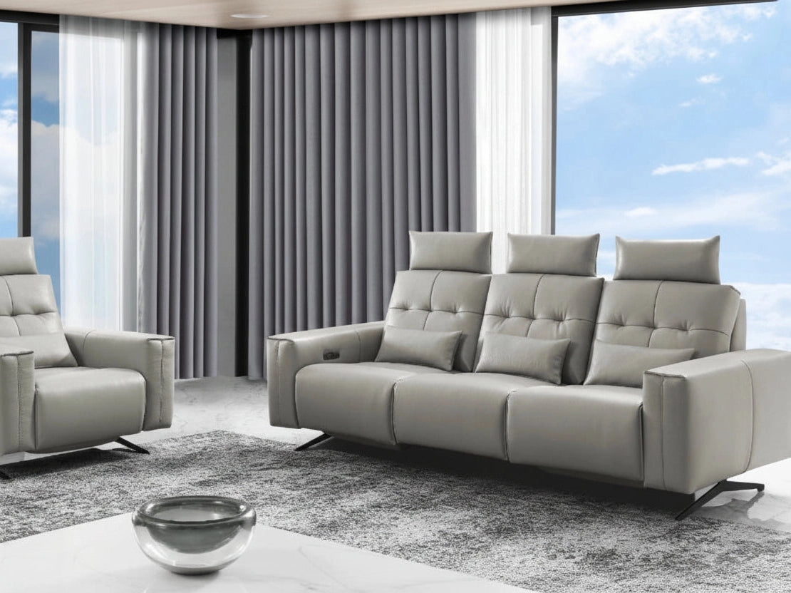 Amalfi gray sofa and armchair set in a modern living room with large windows.