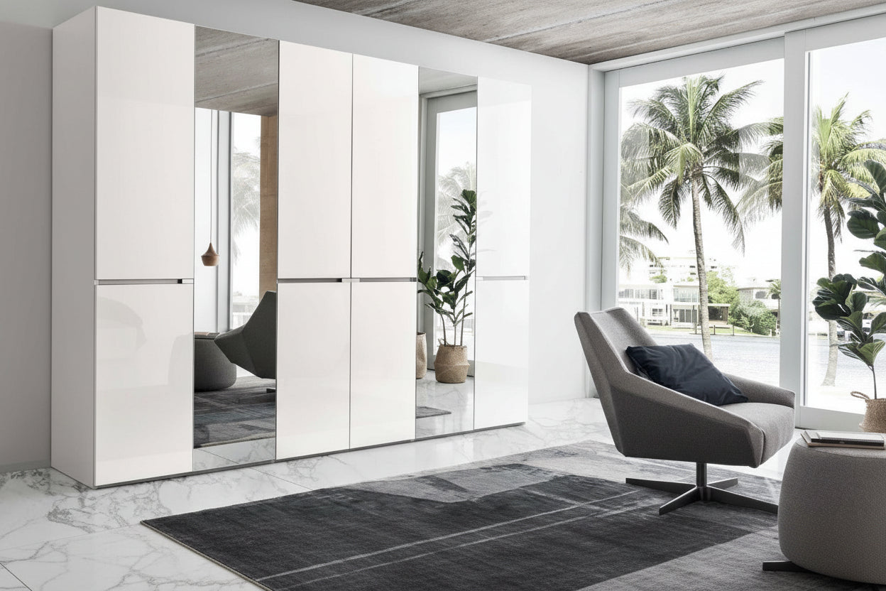 Artemide modern interior design with a white wardrobe and gray chair in a room with large windows.