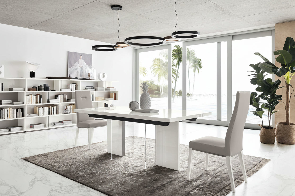 Artemide modern dining room with a white table and gray chairs, large windows, and decorative plants.