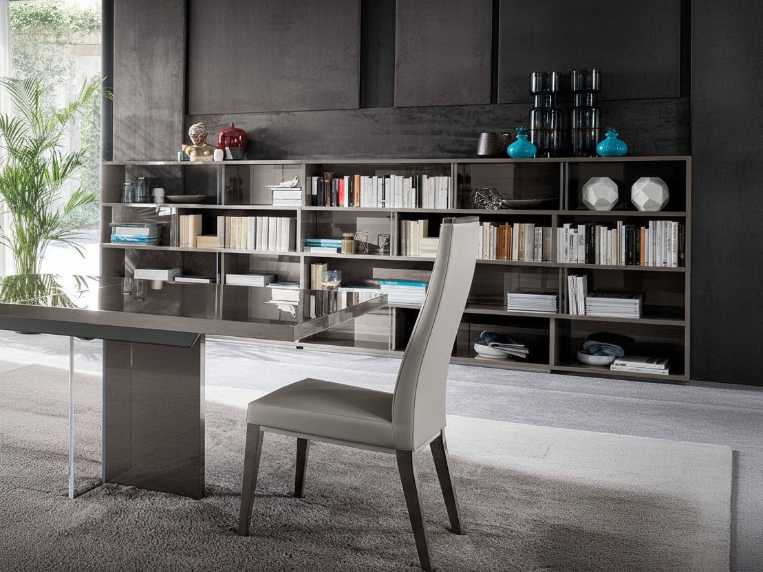 Modern office setup with a desk, chair, and bookshelf.