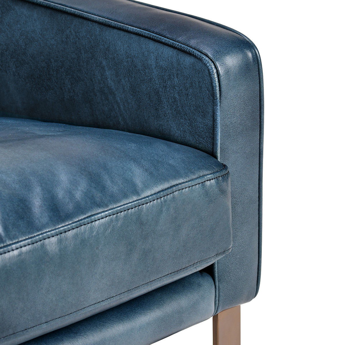 Close-up of a ocean blue leather sofa armrest on a white background