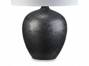 Ladstow table lamp with a black speckled base and white shade on a white background