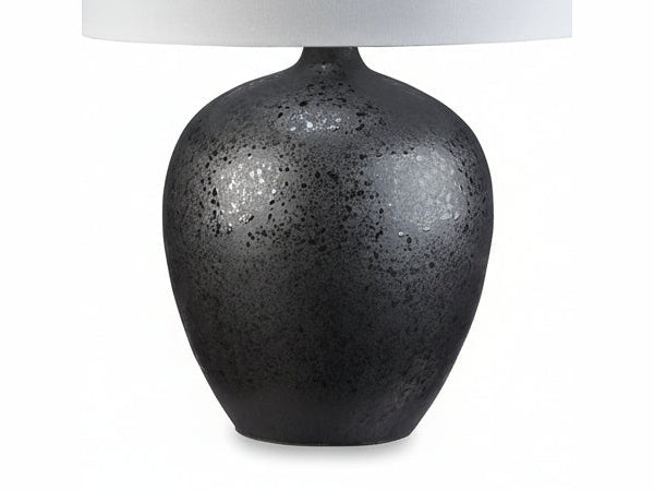 Ladstow table lamp with a black speckled base and white shade on a white background