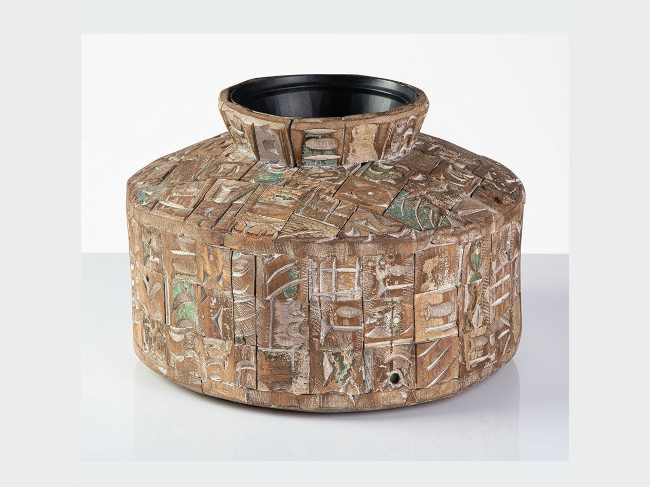 Meltland decorative wooden bowl with intricate carvings on a white background.
