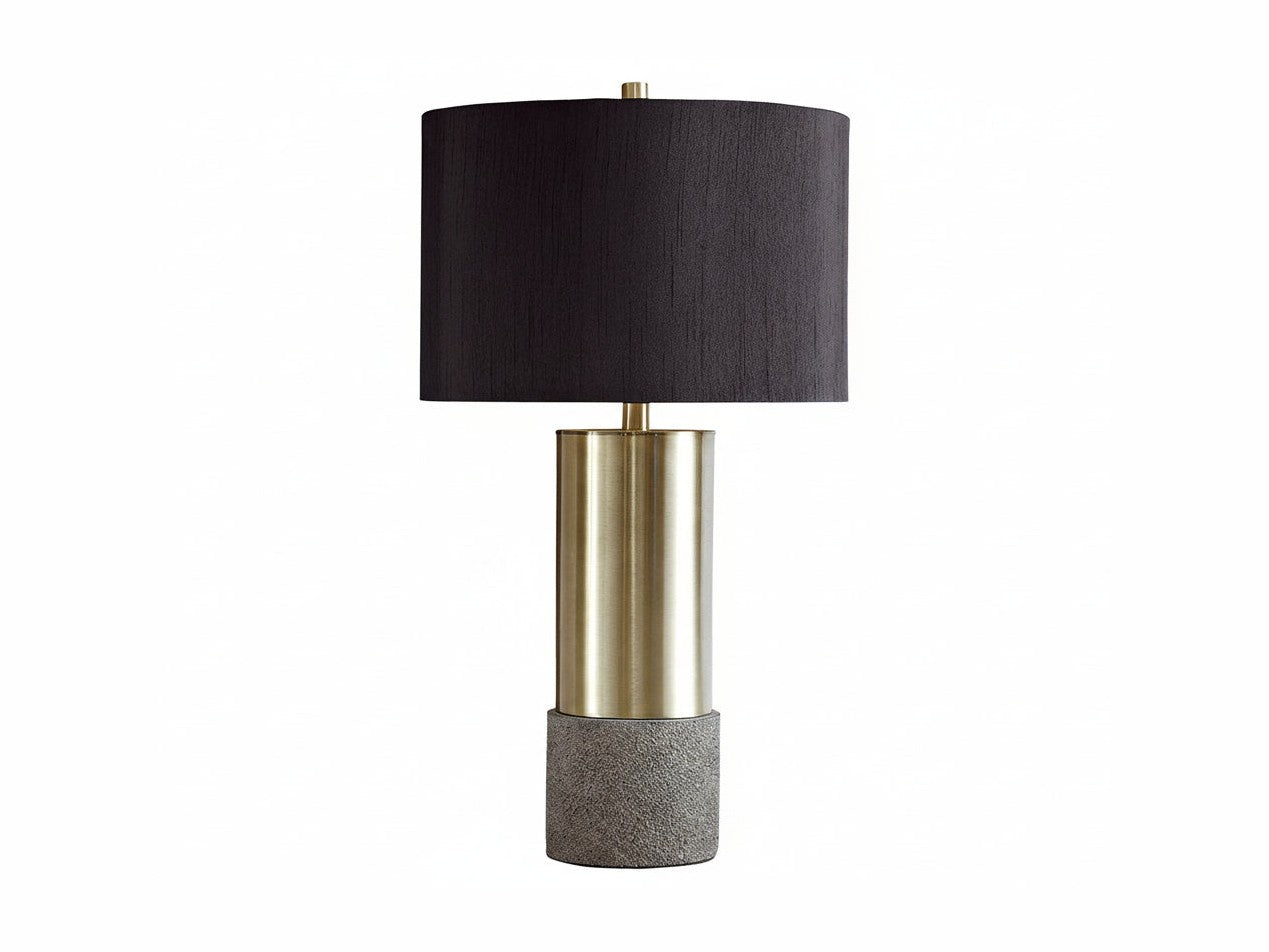 Jacek table lamp with black shade, brass middle section, and textured gray base on a white background