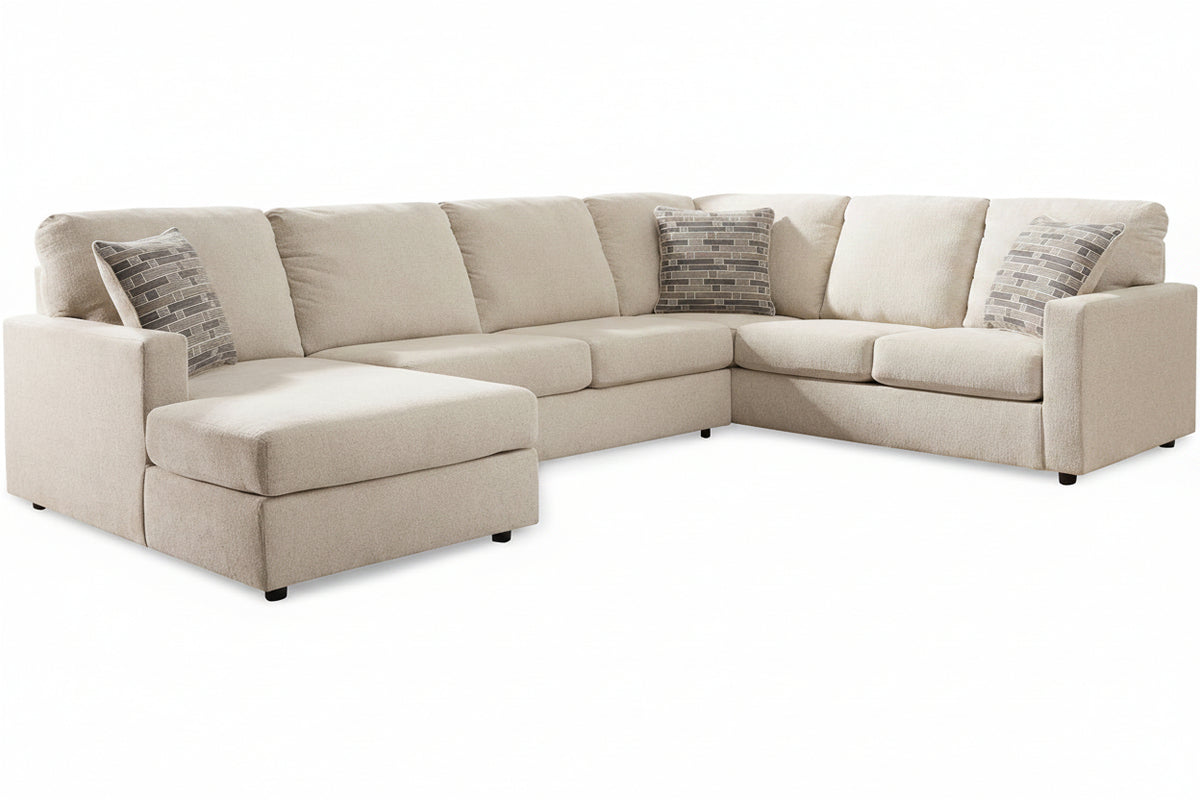 Beige sectional sofa with patterned cushions on a white background