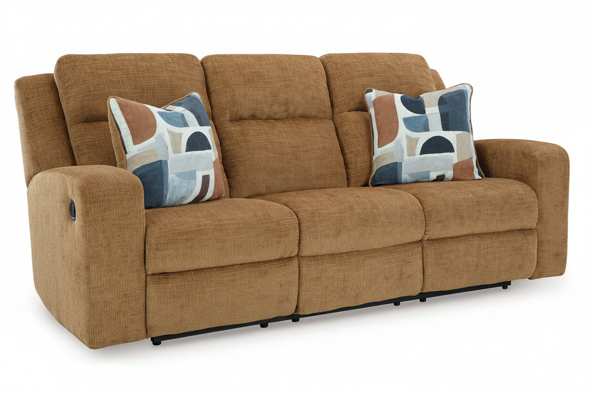 A three-seat power reclining sofa upholstered in a textured tan fabric, featuring two decorative throw pillows with an abstract geometric pattern in blue, brown, and cream, set against a plain white background.