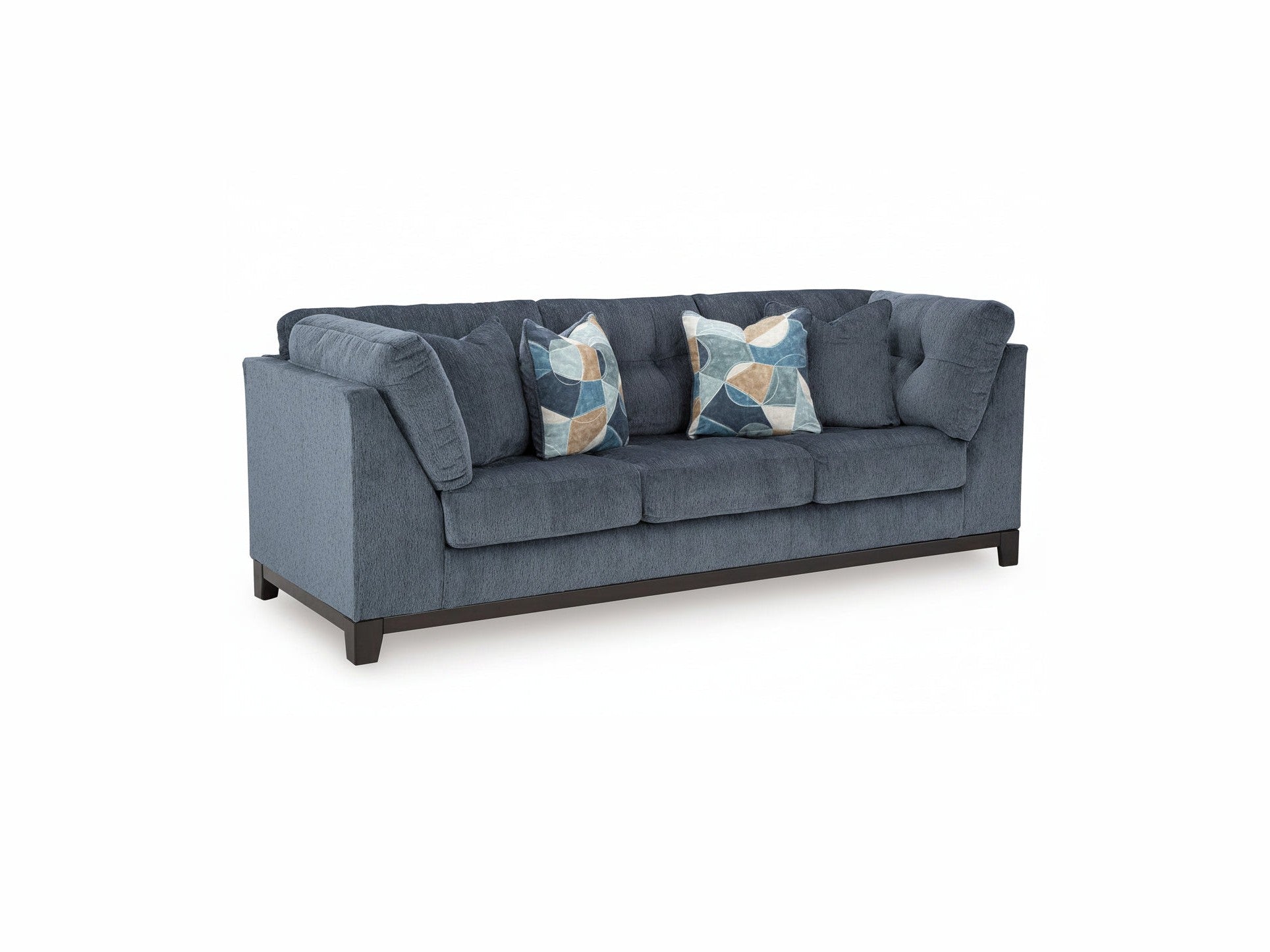 Blue sofa with patterned cushions on a white background
