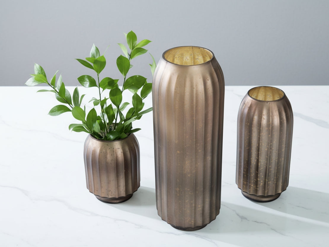 Decorative bronze vase with a ribbed texture on a light background