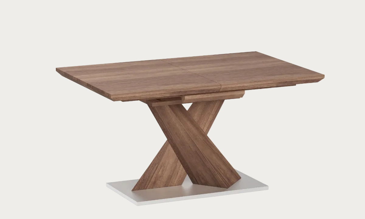 Bethany wooden dining table with a unique X-shaped base on a white background