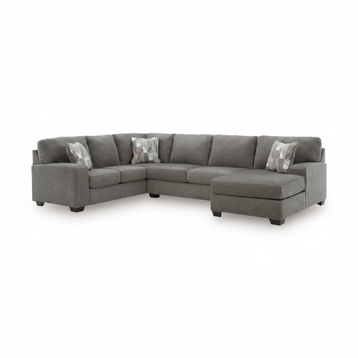 Gray sectional sofa with patterned cushions on a white background