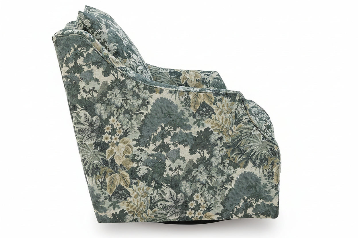 An upholstered armchair with a dense botanical and floral pattern in muted green, beige, and off-white tones, shown against a plain white background.