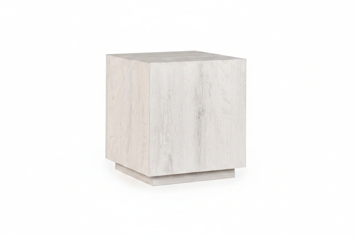 White cube-shaped side table on a white background