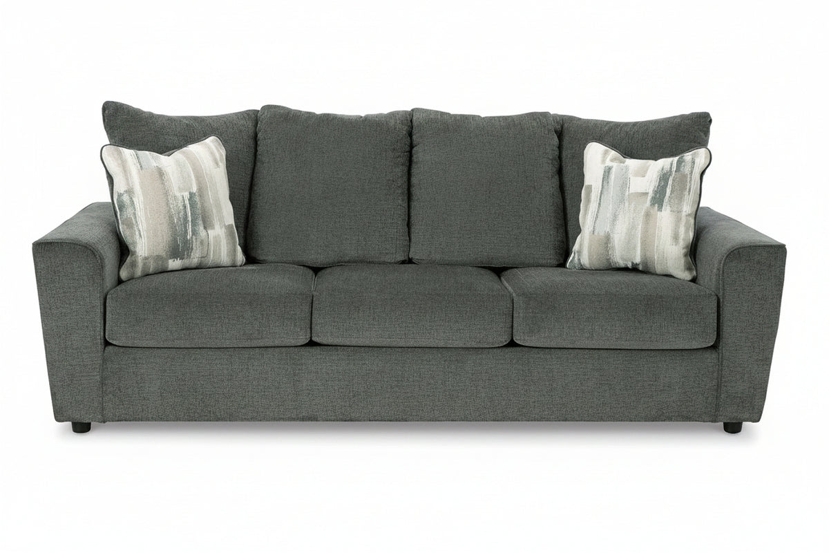 Gray sofa with patterned cushions on a white background