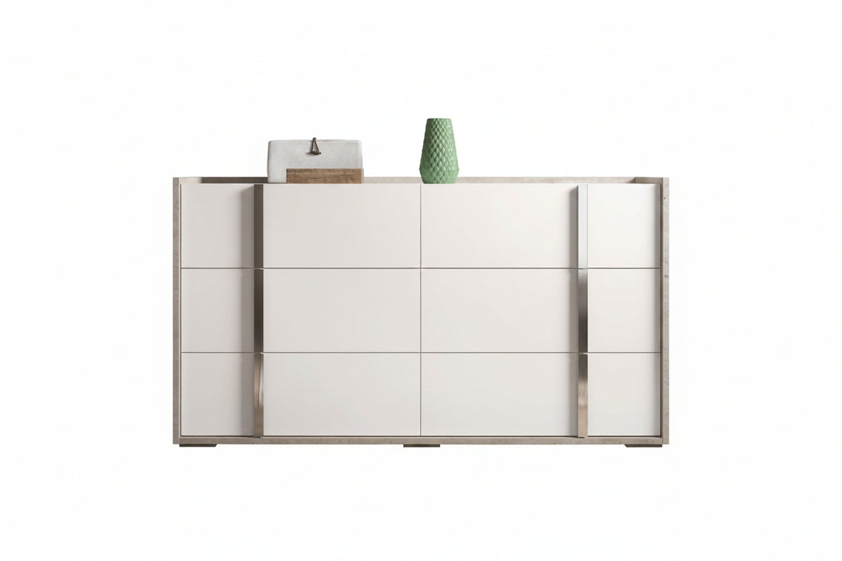 A modern white and silver sideboard cabinet with a minimalist design, featuring a central panel with three drawers and flanked by two larger cabinet doors. Decorative items, including a green vase and a small box, are placed on top, set against a plain white background.