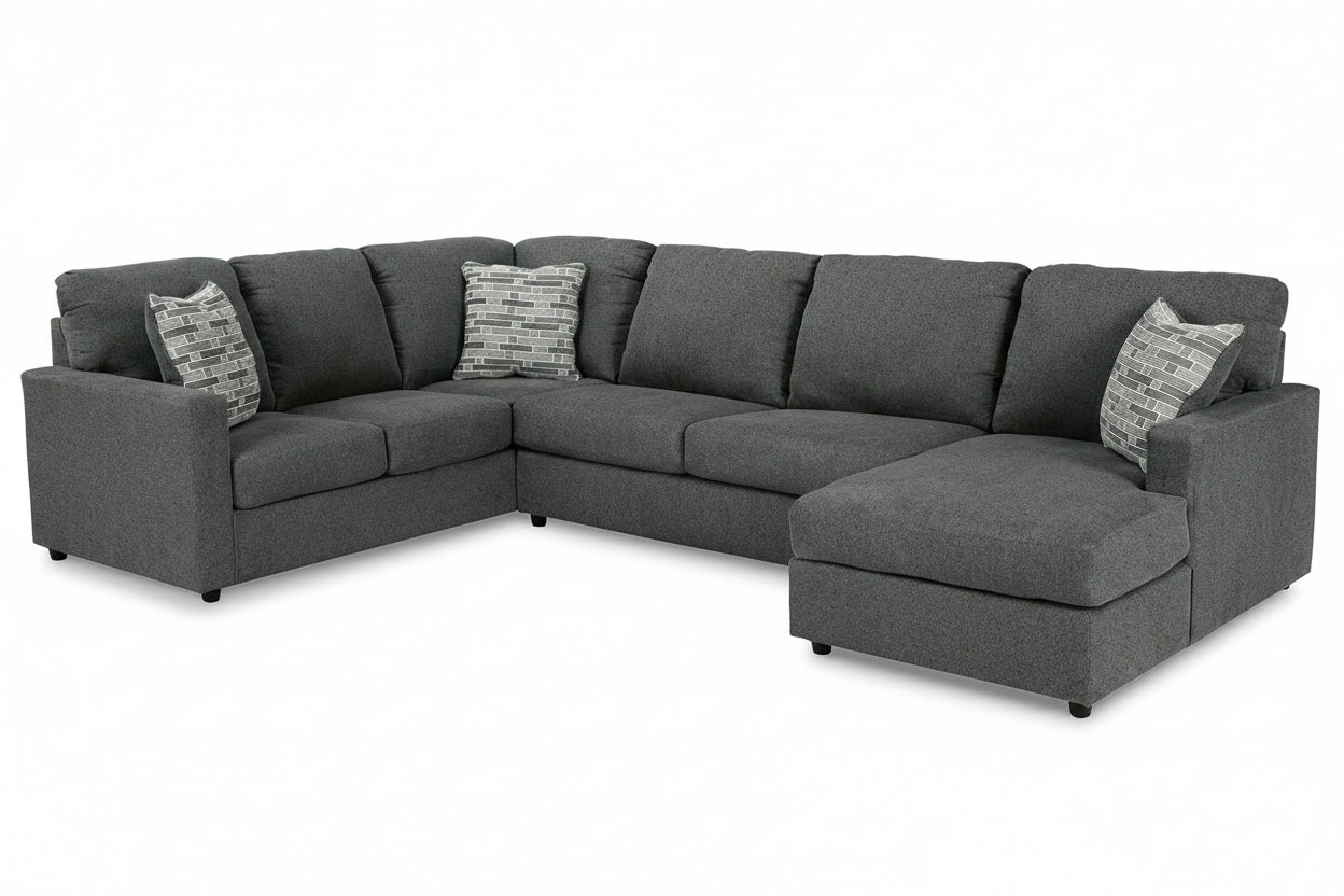 Gray sectional sofa with patterned cushions on a white background