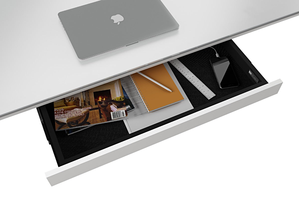 Desk with a laptop and various items in an open drawer