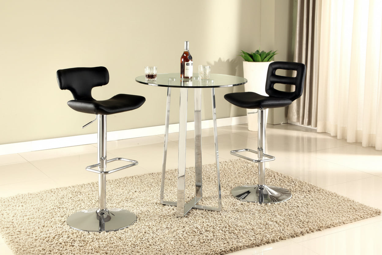 The Chambers two black bar stools with chrome bases in front of a glass dining table.