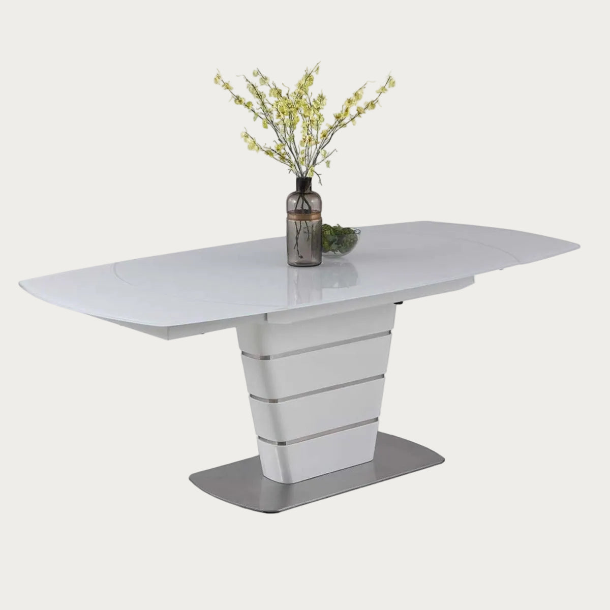 Charlotte white dining table with a vase of flowers on a white background
