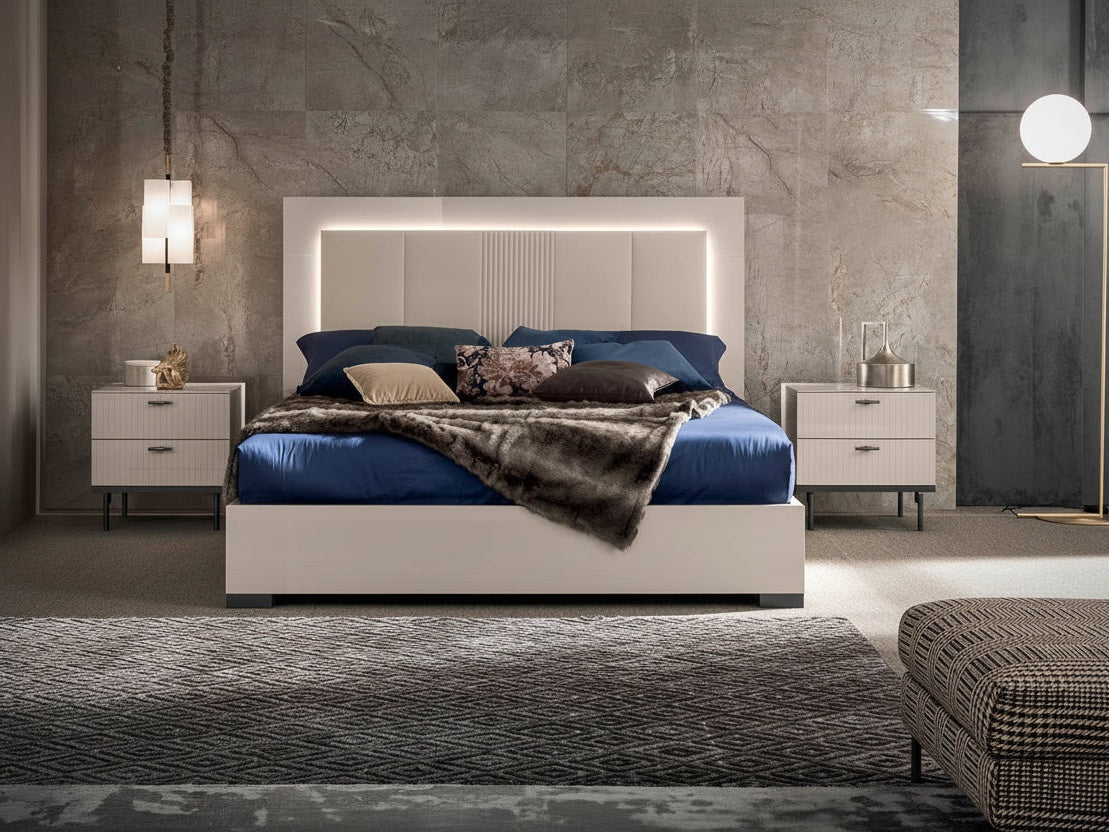 Claire modern bedroom set with a large bed, nightstands, and decorative items.