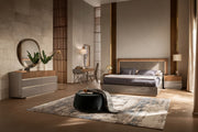The Corso Como modern bedroom features a bed, nightstands, and decorative elements.